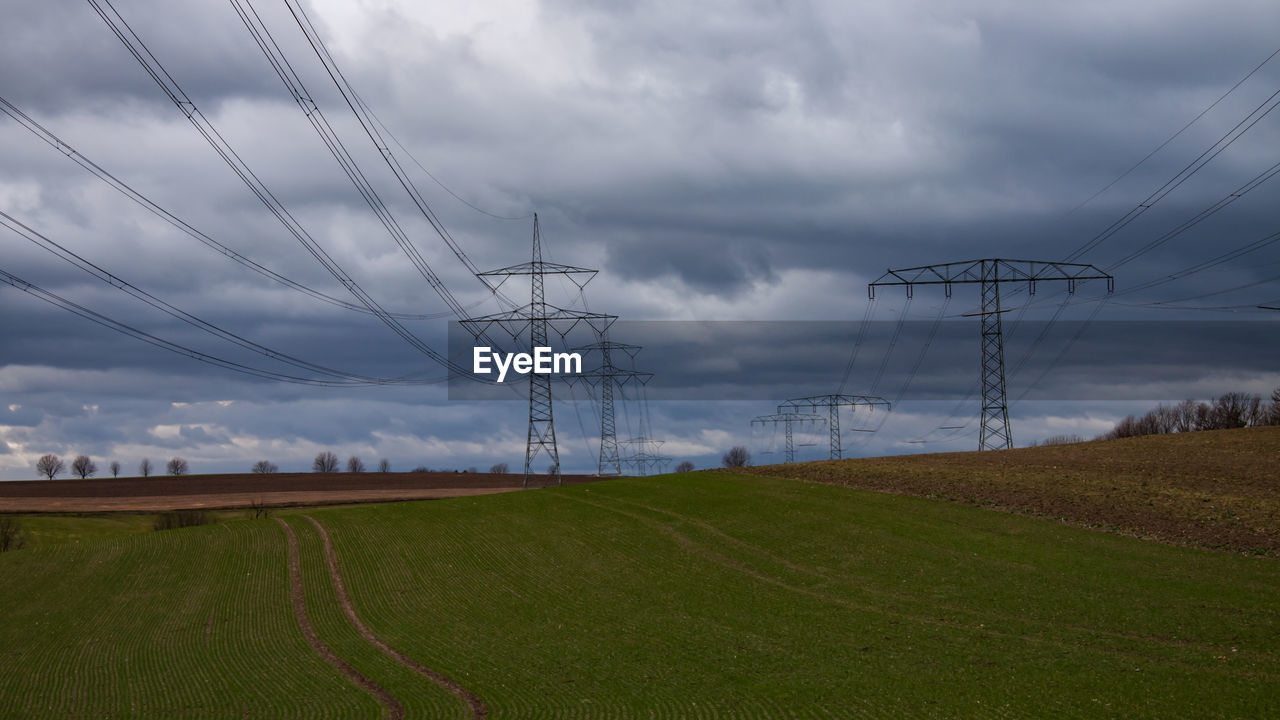 ELECTRICITY PYLON ON LAND AGAINST SKY