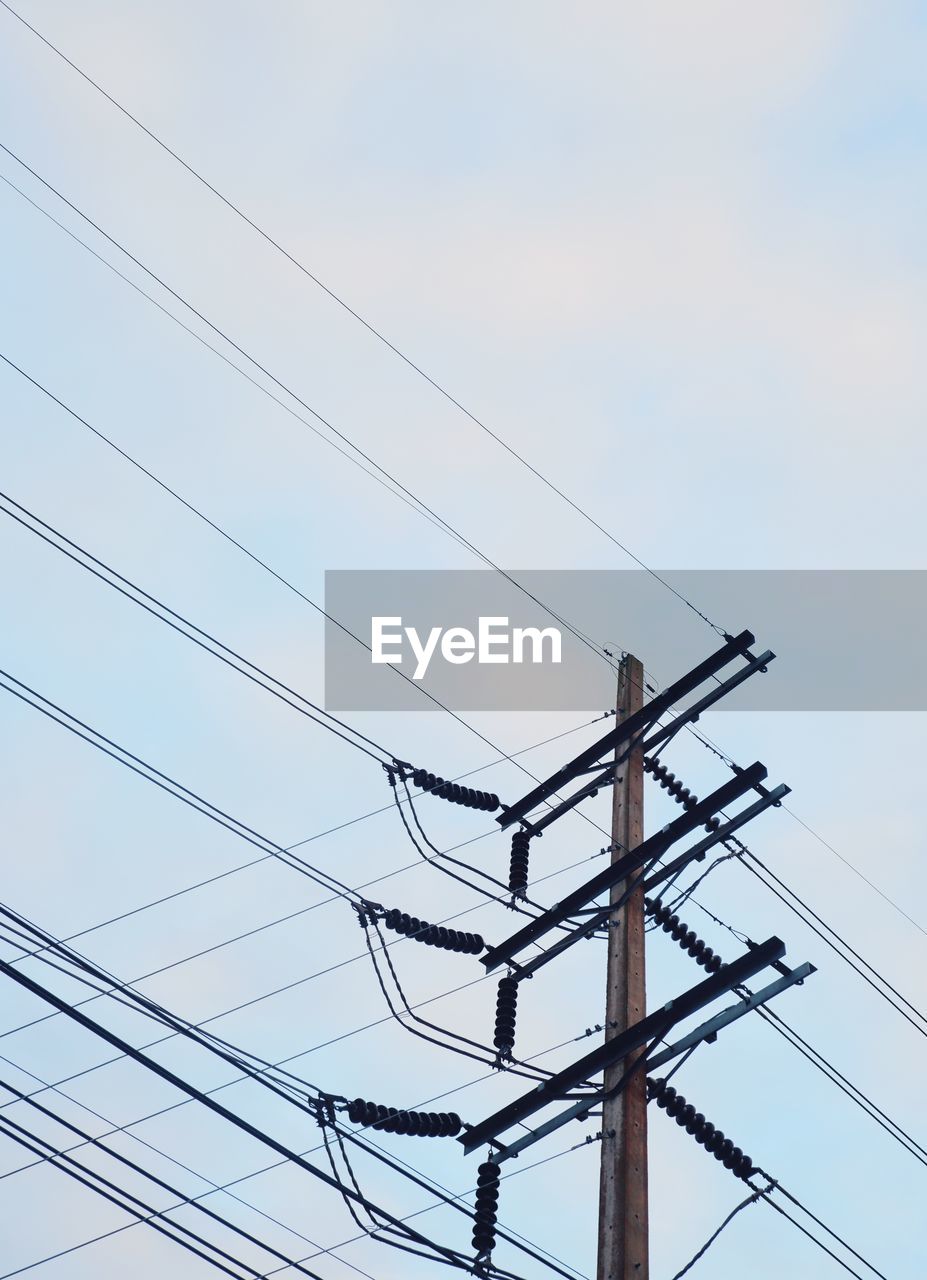 Low angle view of electricity pylon against clear sky