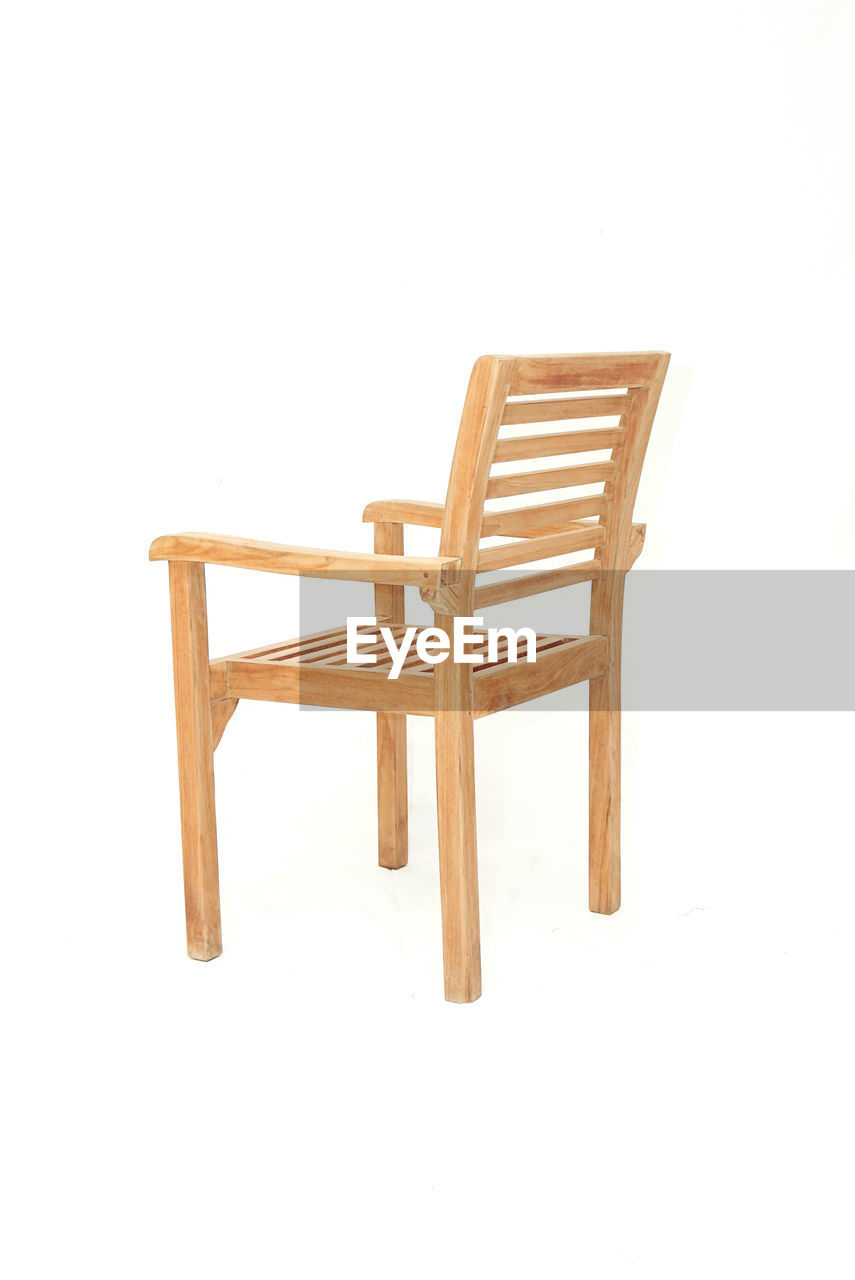 EMPTY CHAIR AGAINST WHITE BACKGROUND