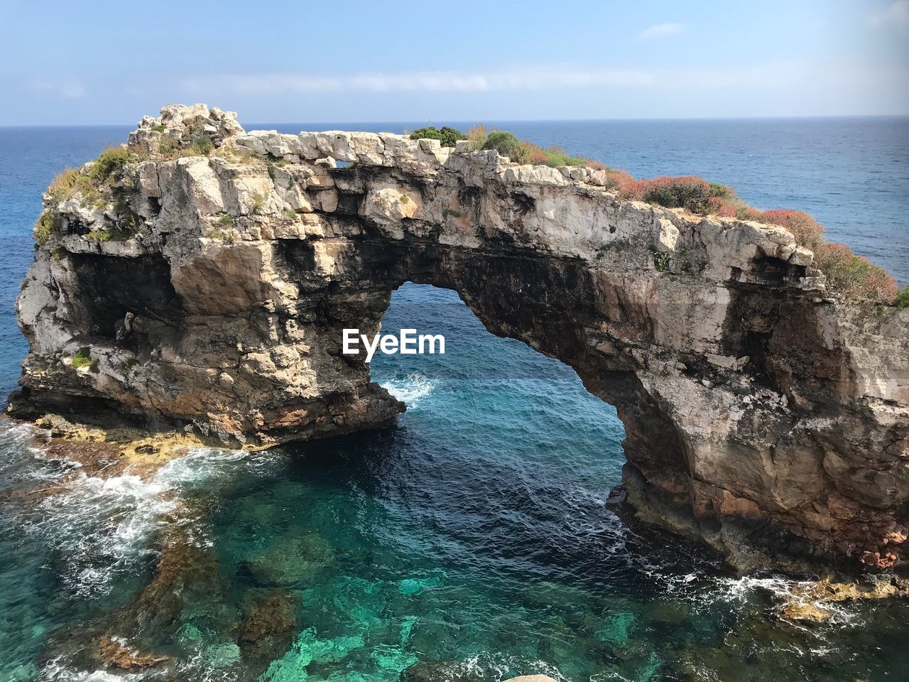 Rock formations in sea against sky