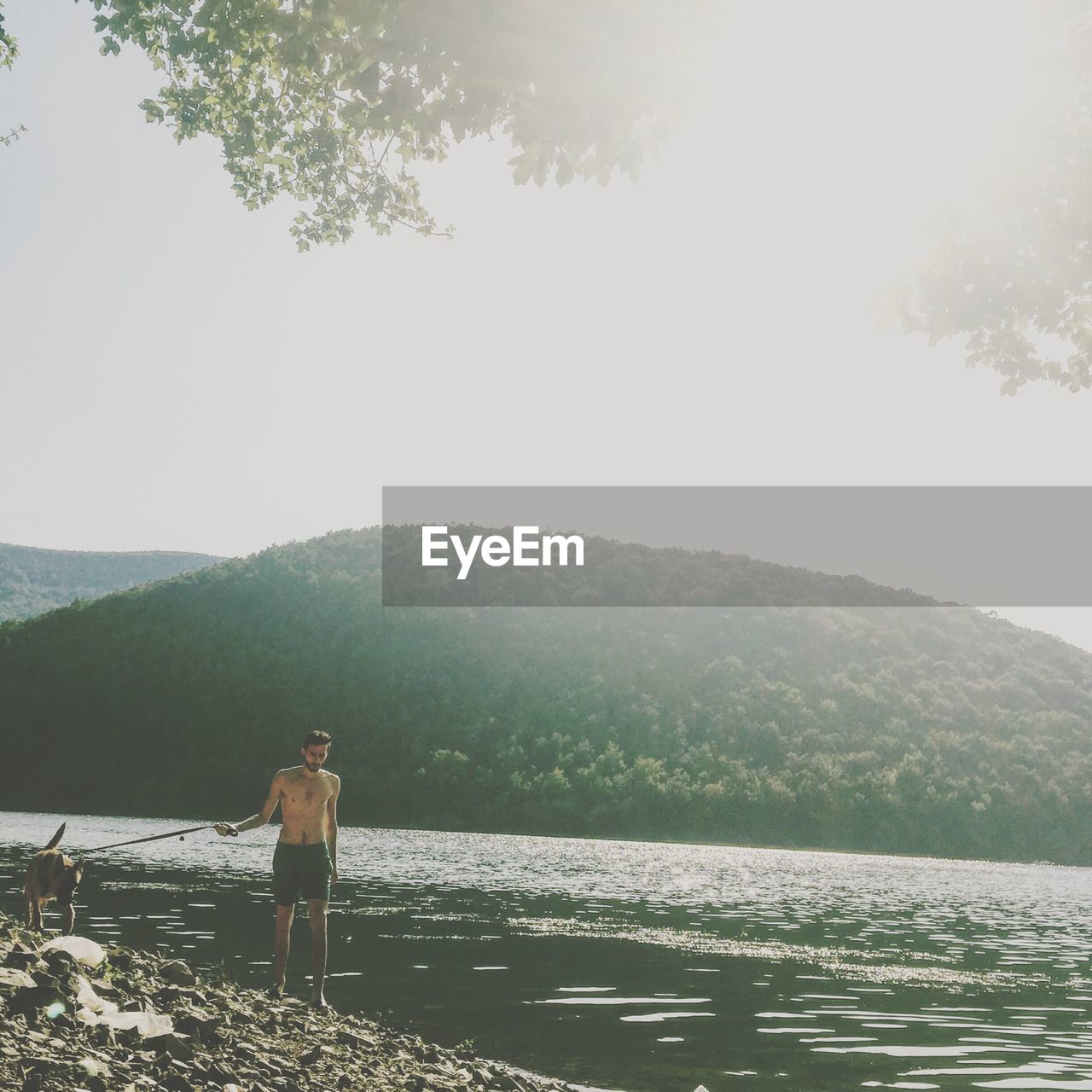 SCENIC VIEW OF LAKE WITH MOUNTAINS IN BACKGROUND