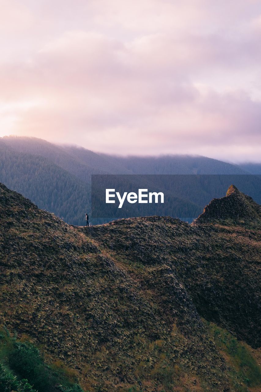 Scenic view of mountains against cloudy sky