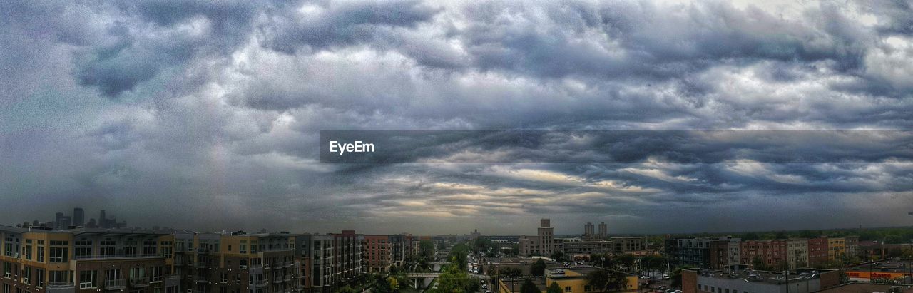 VIEW OF CITYSCAPE AGAINST CLOUDY SKY