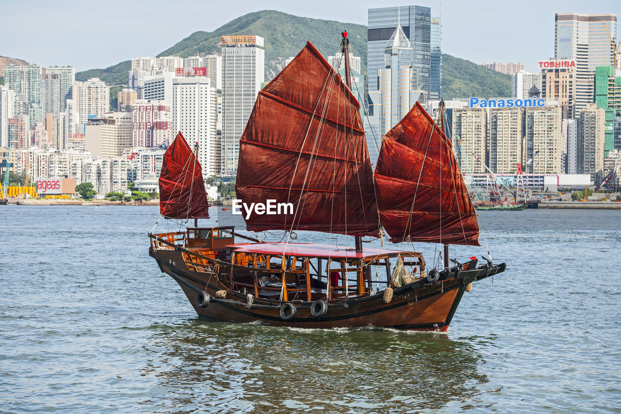 Traditional junk boat at victoria harbour in hong kong