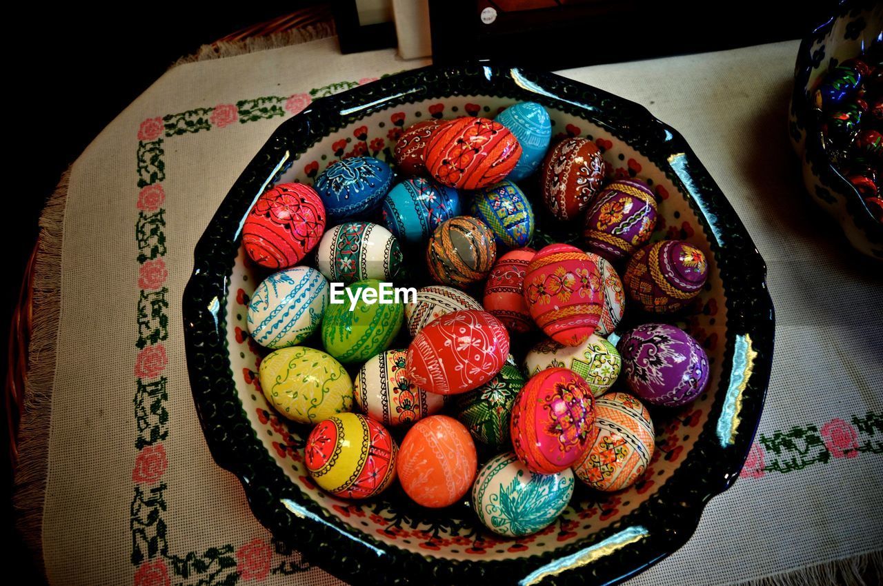 High angle view of colorful easter eggs in bowl on table