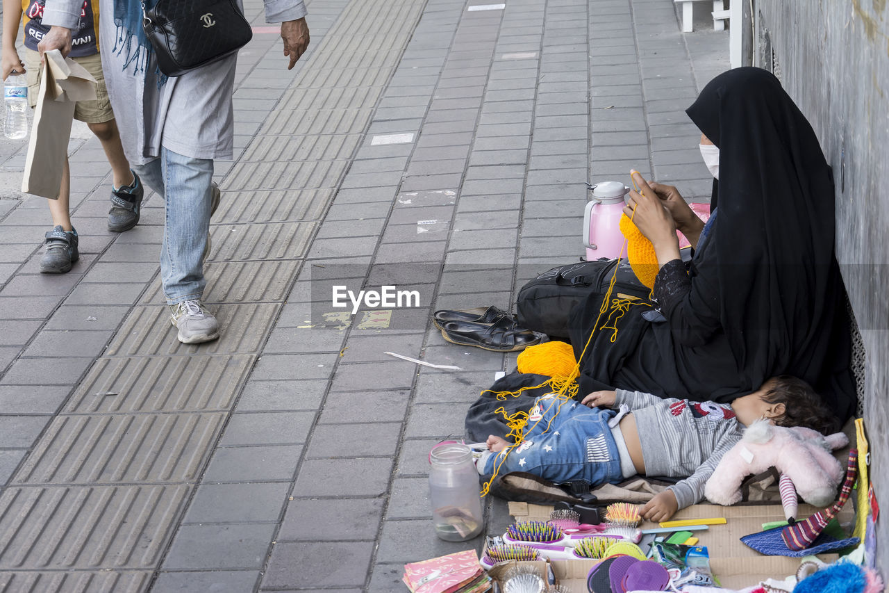 PEOPLE ON FOOTPATH IN CITY