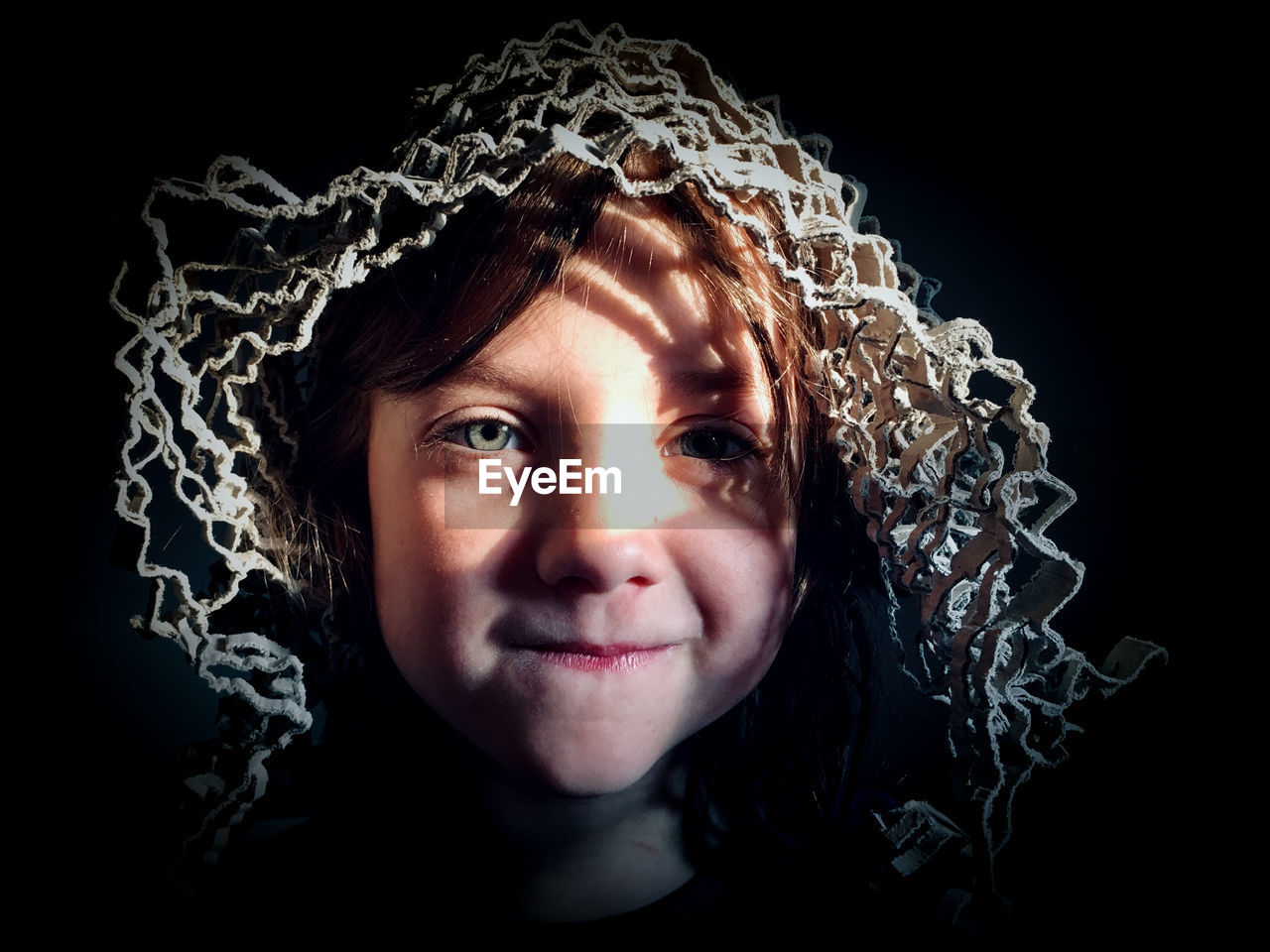 Close-up of girl over black background