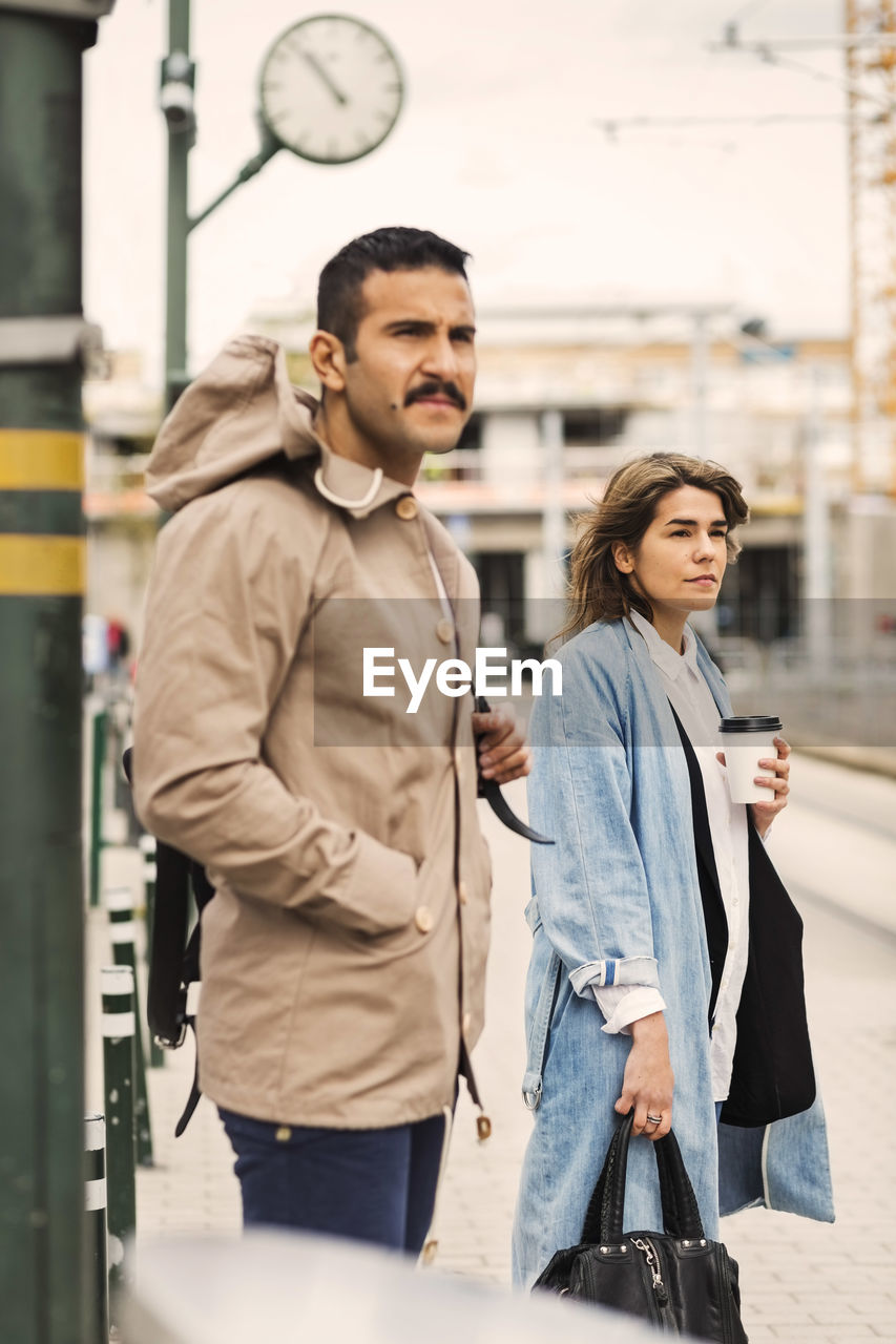 Man and woman waiting at tram station