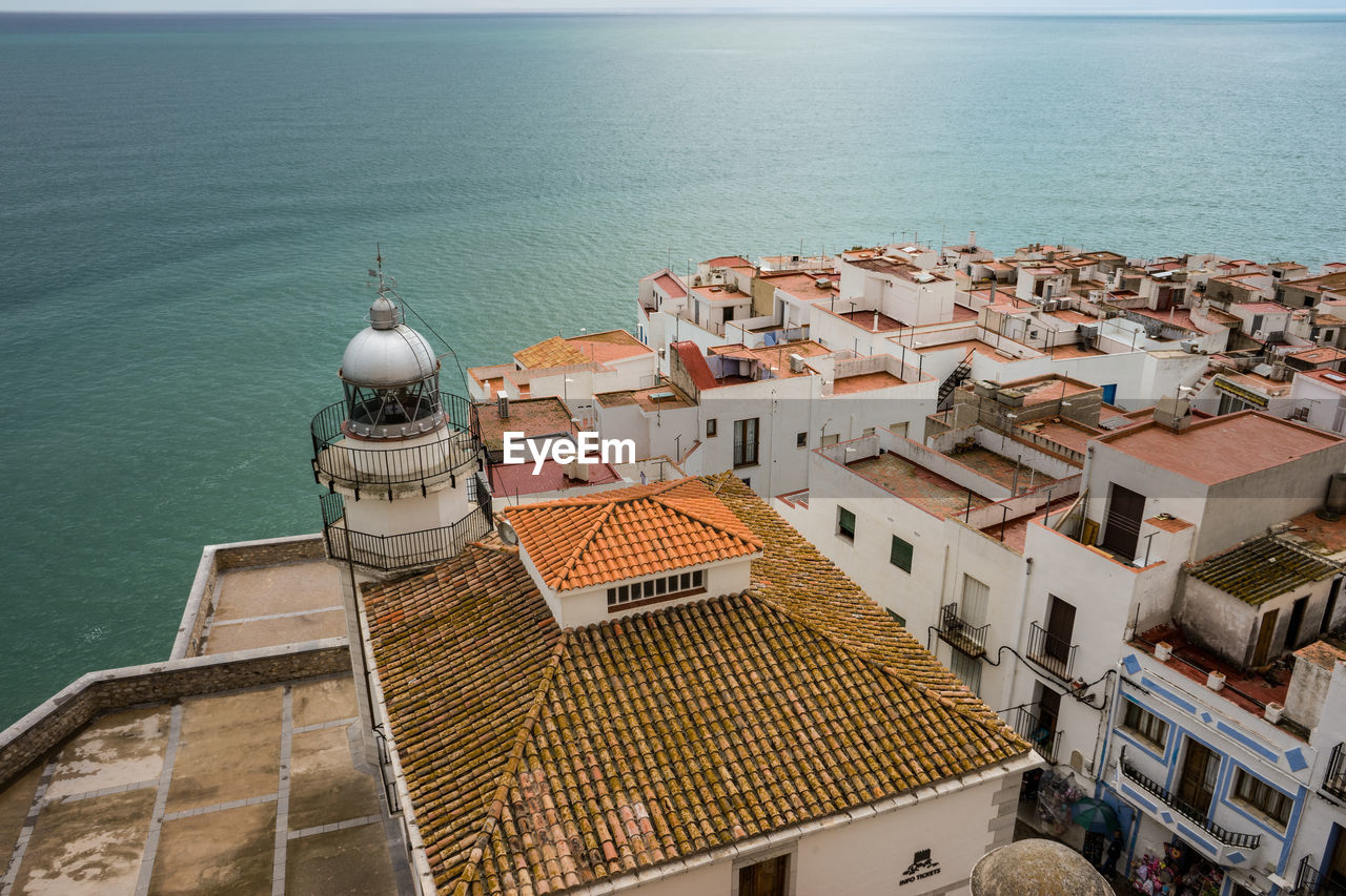 High angle view of townscape by sea