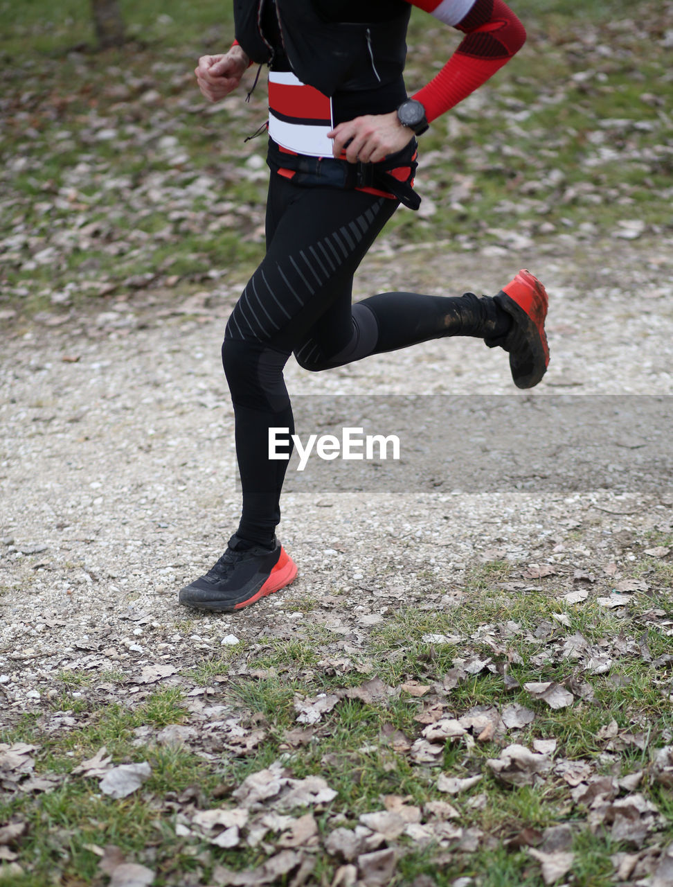 LOW SECTION OF BOY RUNNING ON FIELD