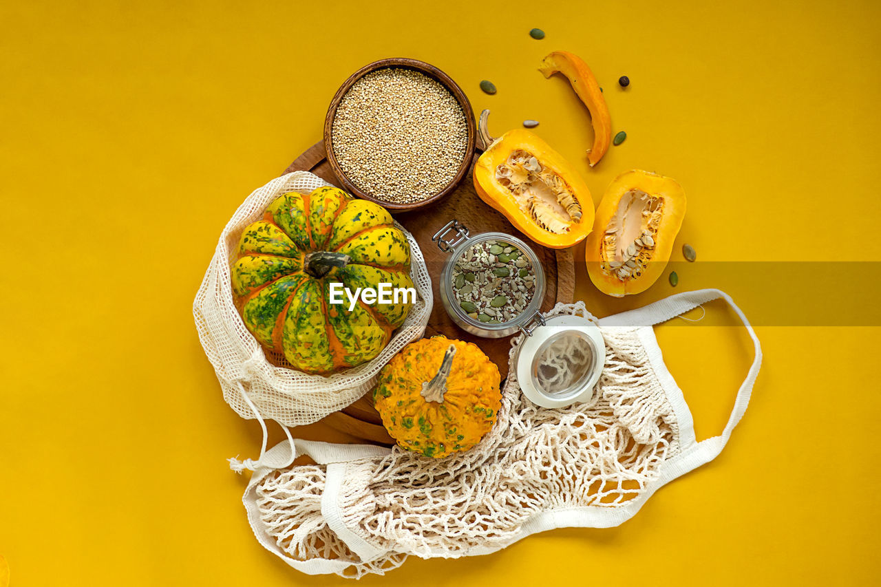 yellow, food and drink, colored background, food, healthy eating, studio shot, fruit, flower, yellow background, indoors, no people, wellbeing, still life, freshness, produce, citrus fruit, directly above, leaf, high angle view