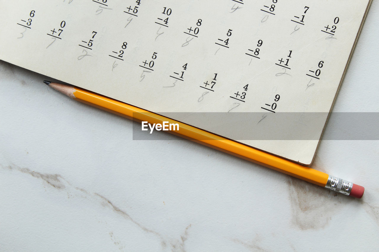 High angle view of pencil on book at table