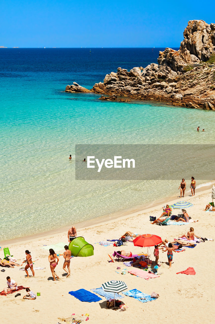 High angle view of people at beach on sunny day