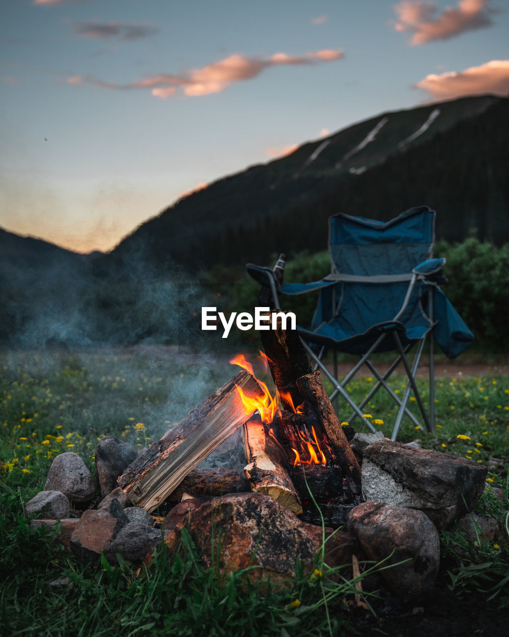 BONFIRE ON FIELD AGAINST SKY