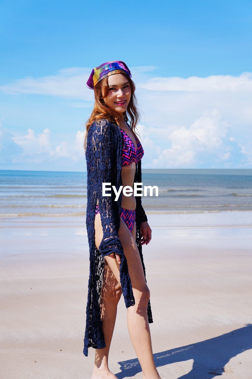 Portrait of beautiful young woman on shore of beach