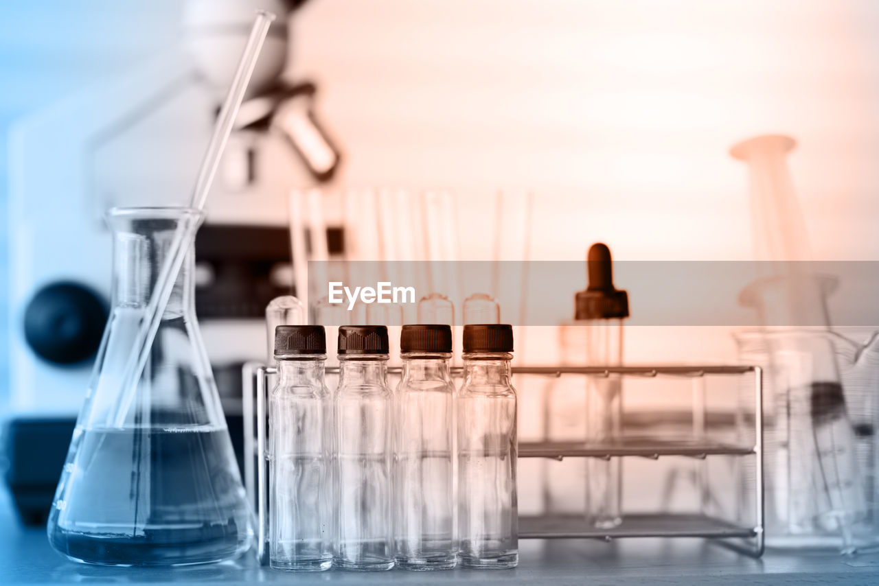 Close-up of beaker with test tubes on table at laboratory