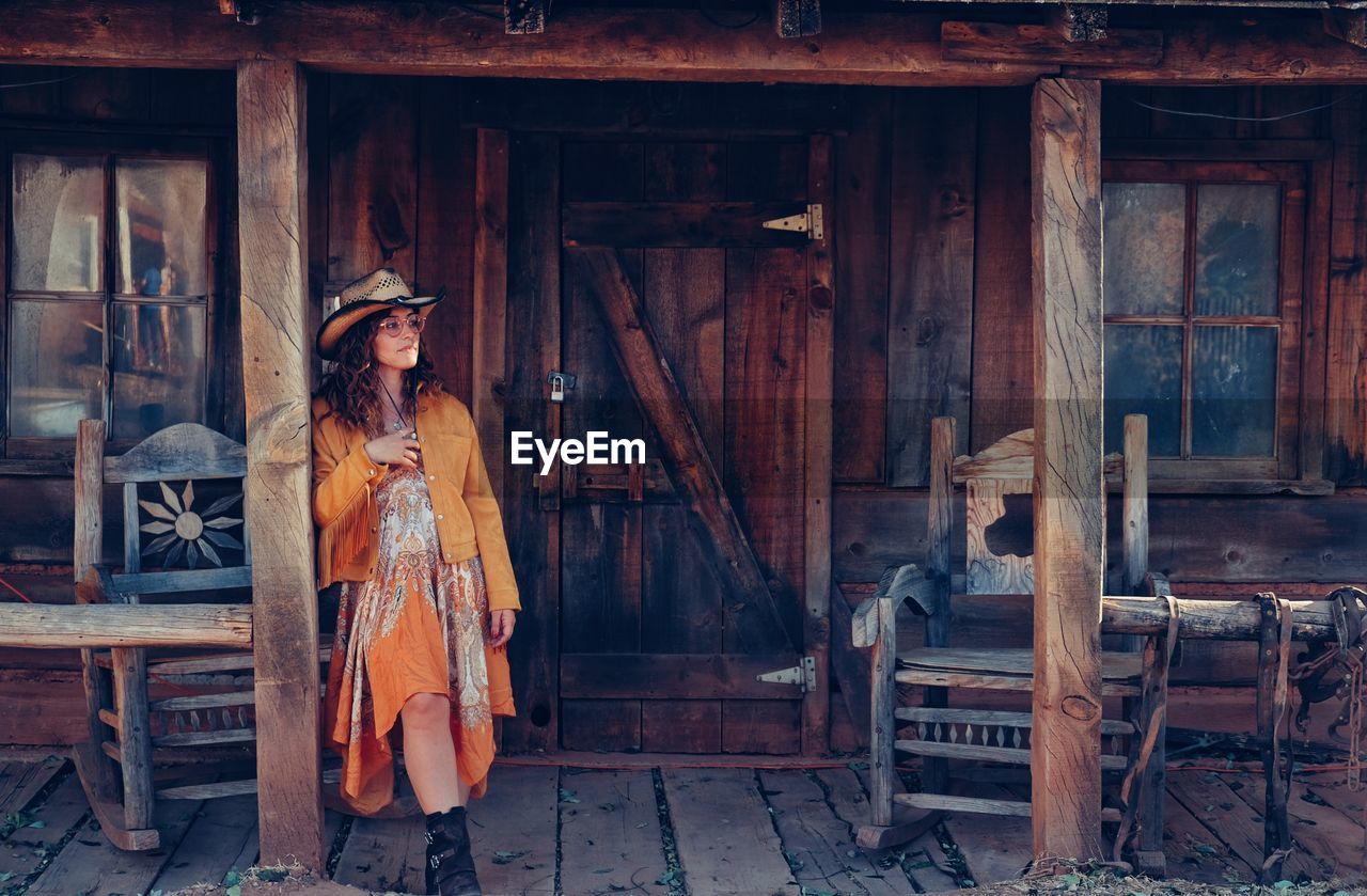 Woman standing in front of hut