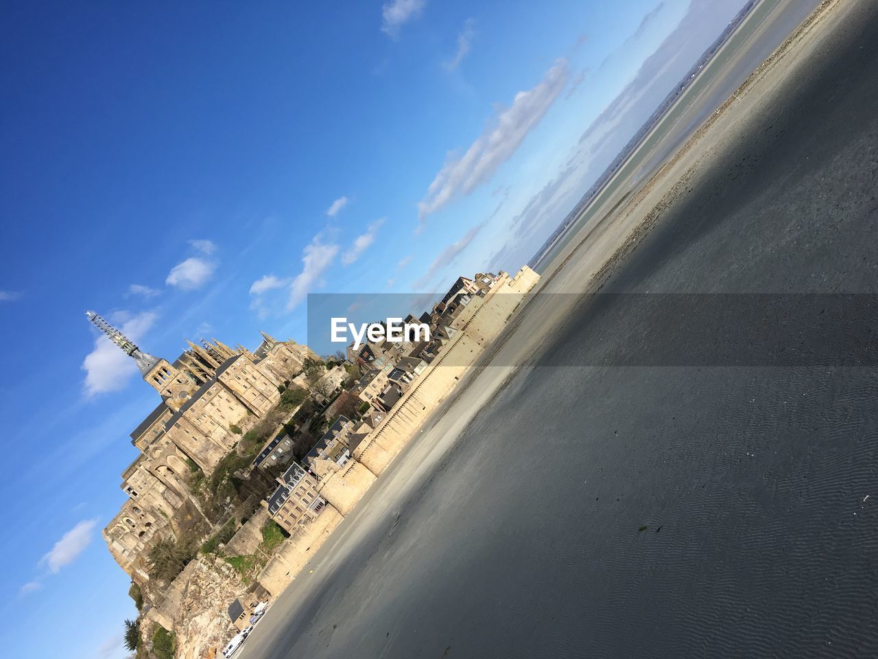 Tilt image of mont saint-michel against sky