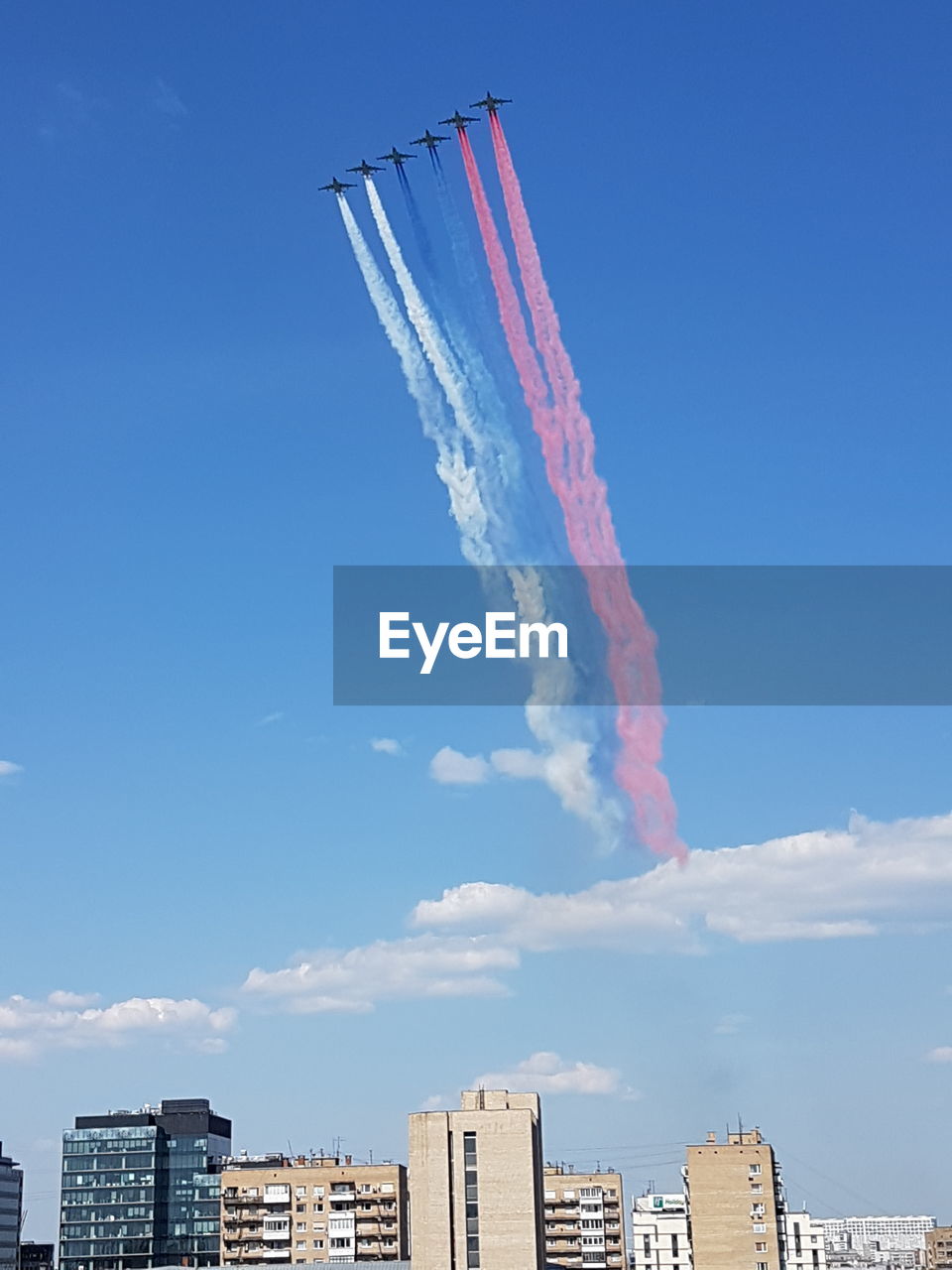 Low angle view of airplane flying against clear blue sky