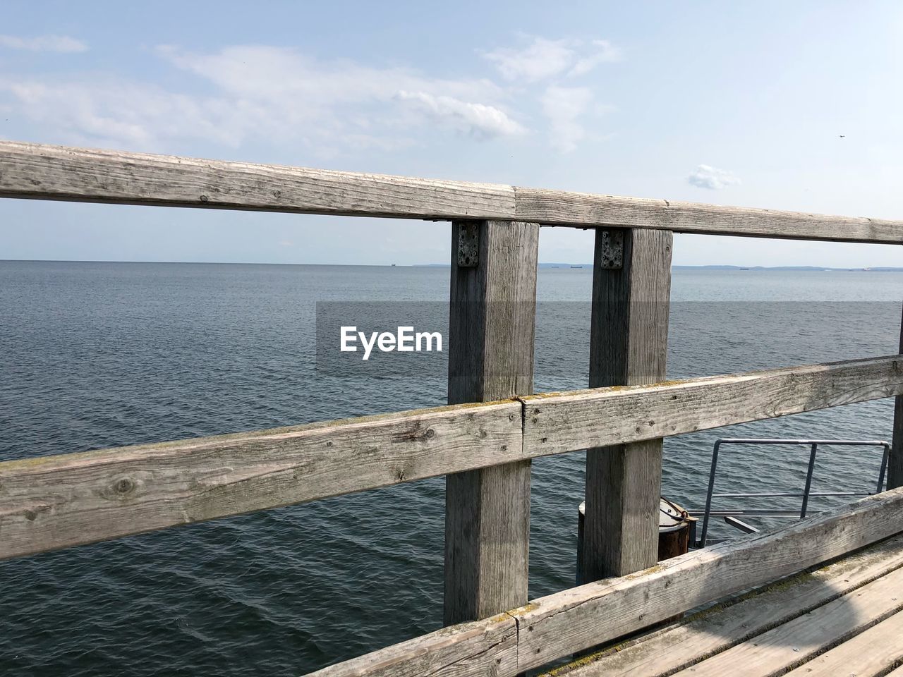 PIER AMIDST SEA AGAINST SKY