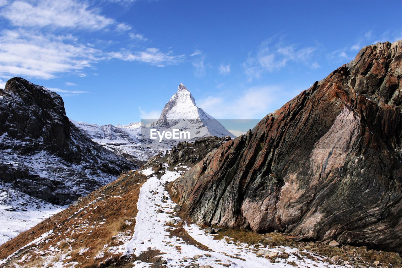 Scenic view of matterhorn mountain with sunny day clear blue sky.  stock photo copy space 