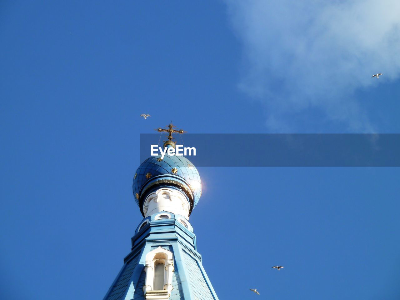 LOW ANGLE VIEW OF BELL TOWER AGAINST BLUE SKY