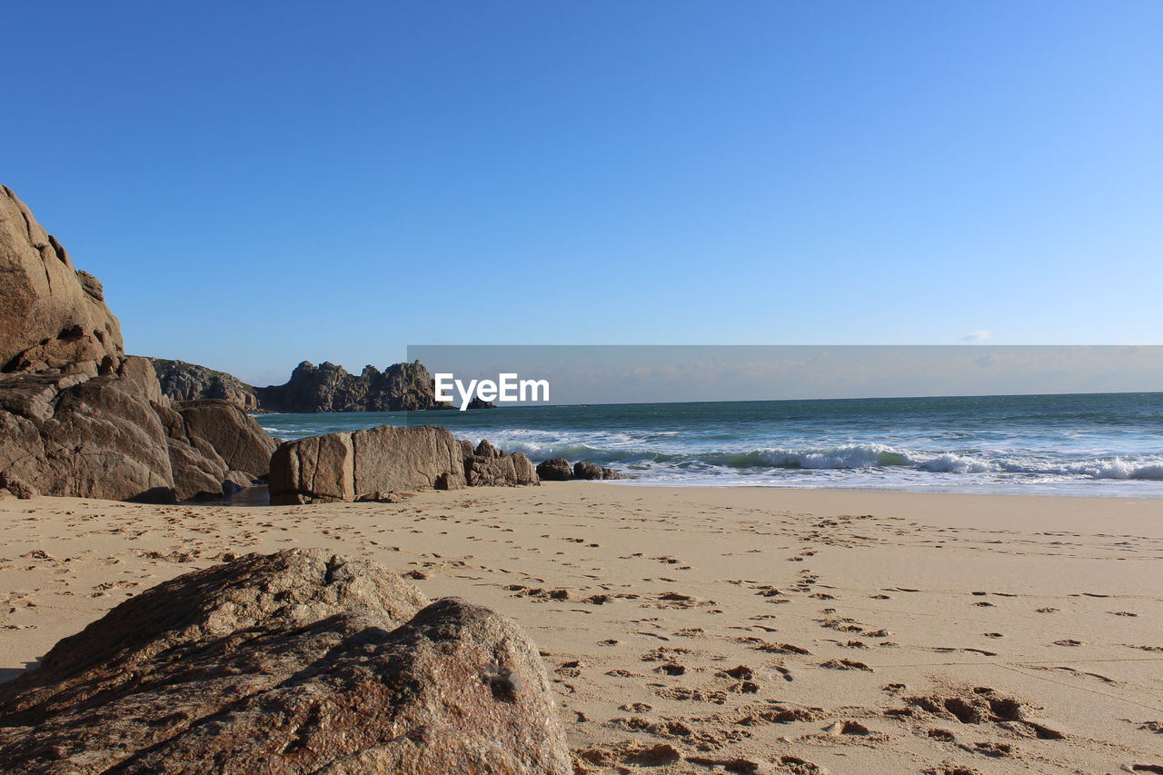 Scenic view of beach against clear sky
