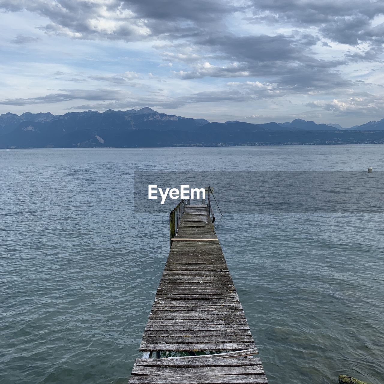 Pier on lake against sky