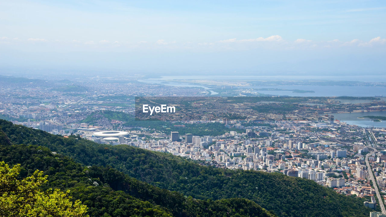 HIGH ANGLE SHOT OF CITYSCAPE AGAINST SKY