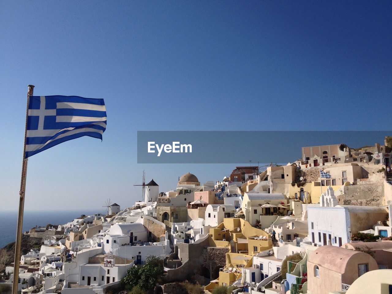Greek flag waving at oia