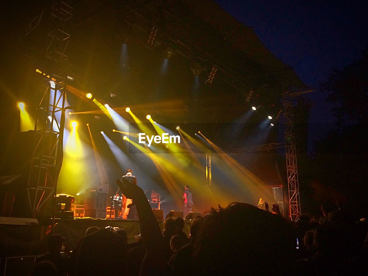 Low angle view of man performing on stage during music festival
