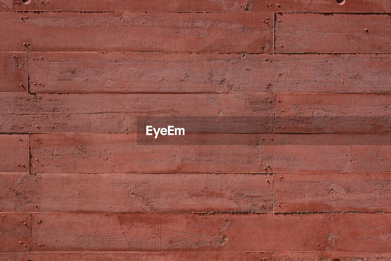 Texture of a red concrete wall texture horizontal make with wood formwork