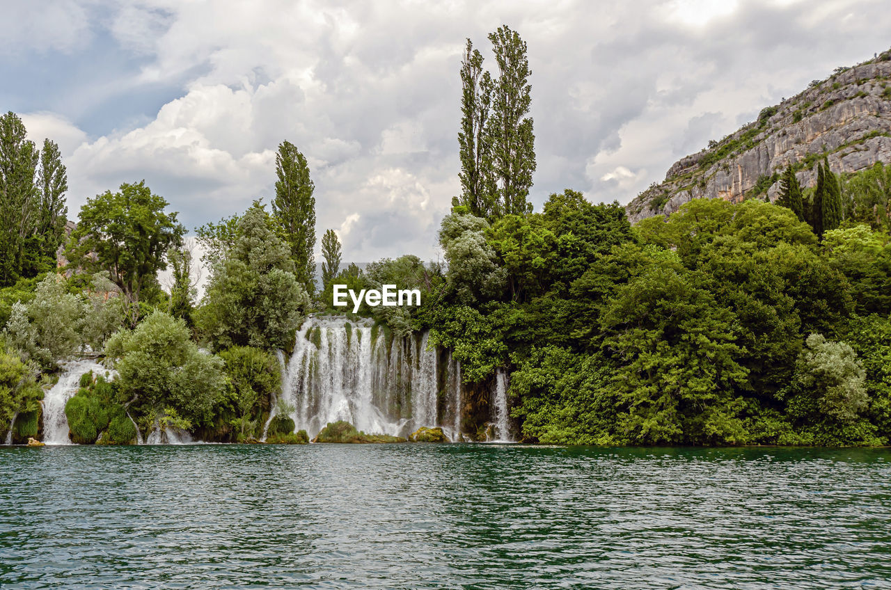 SCENIC VIEW OF LAKE AMIDST TREES AGAINST SKY