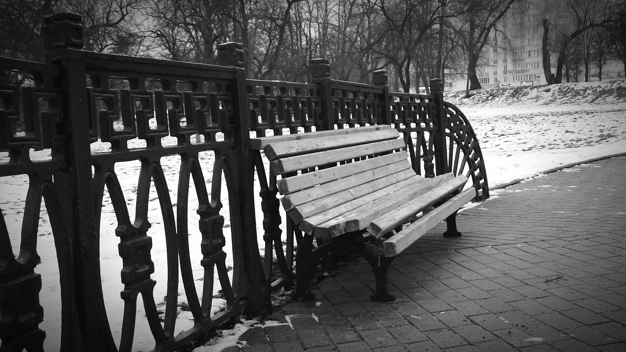 EMPTY BENCHES ON FOOTPATH IN PARK