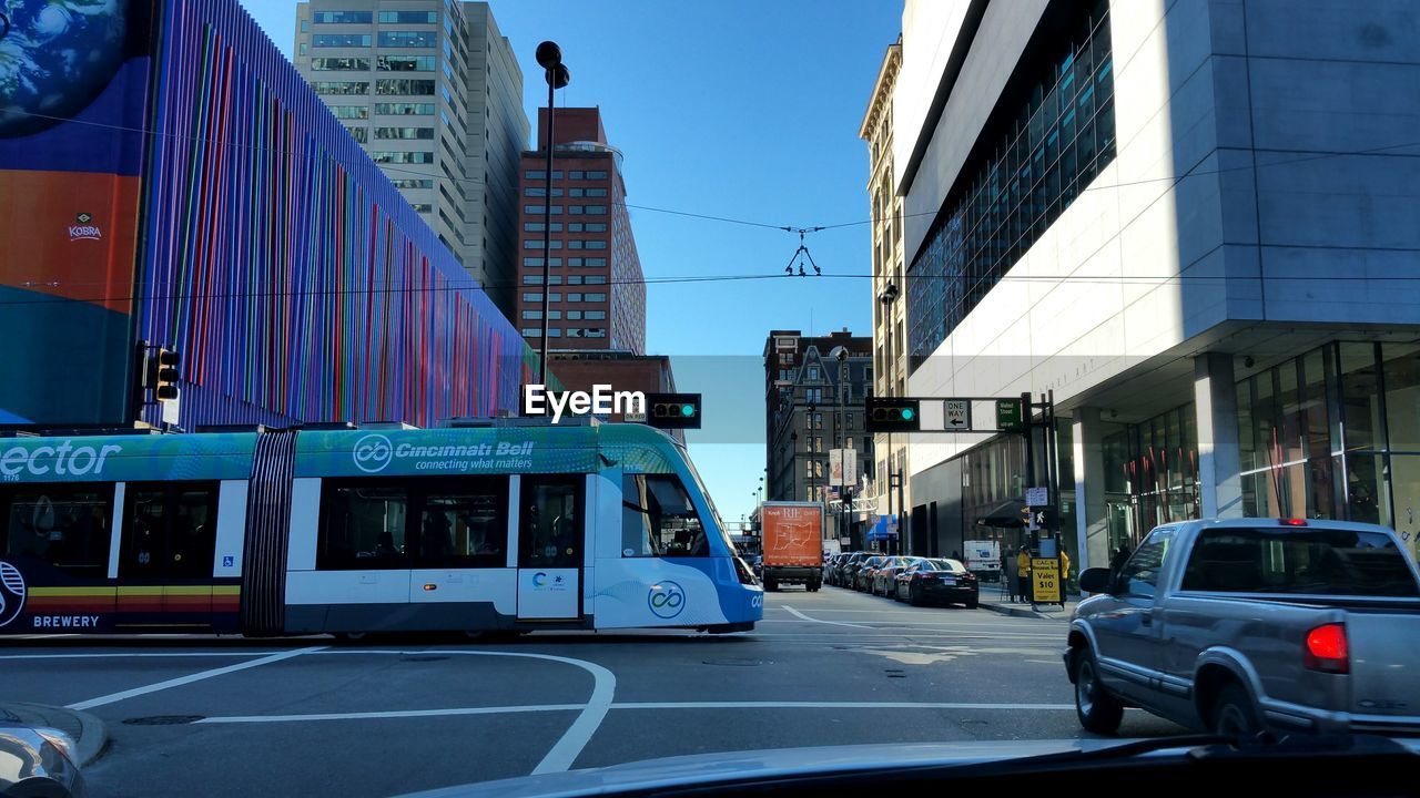 CARS ON ROAD AGAINST BLUE SKY