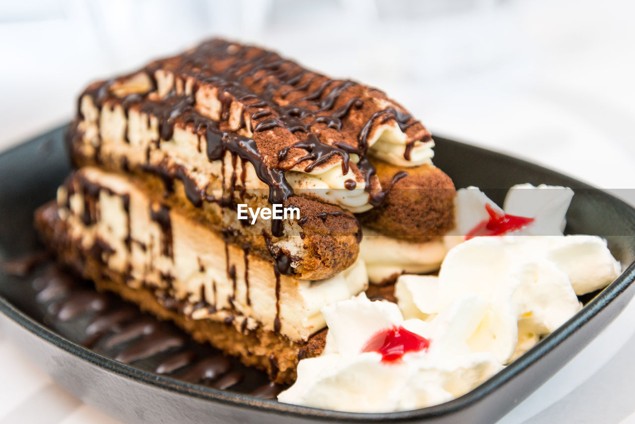 Close-up of tiramisu cake in container on table