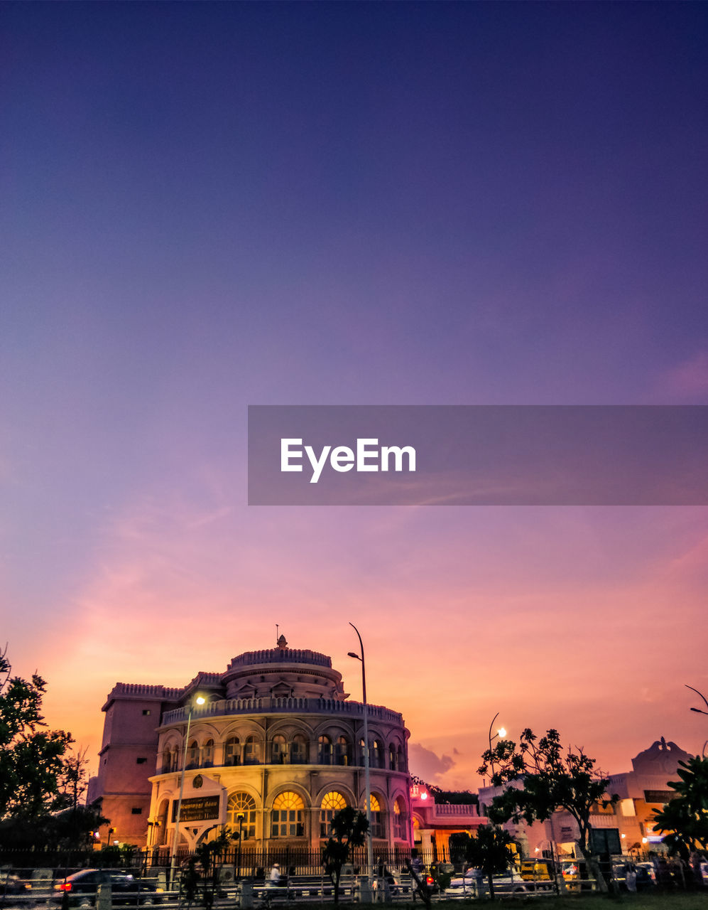 Buildings in city against sky during sunset