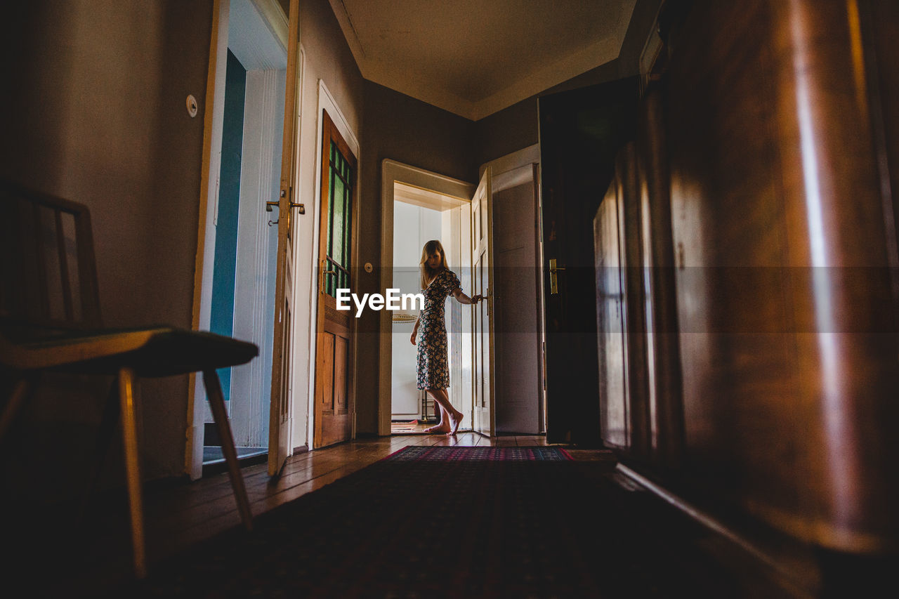 Woman standing at door 