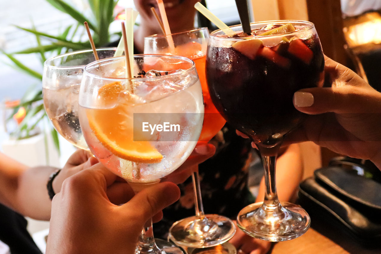 Close-up of hand holding glass of wine in restaurant