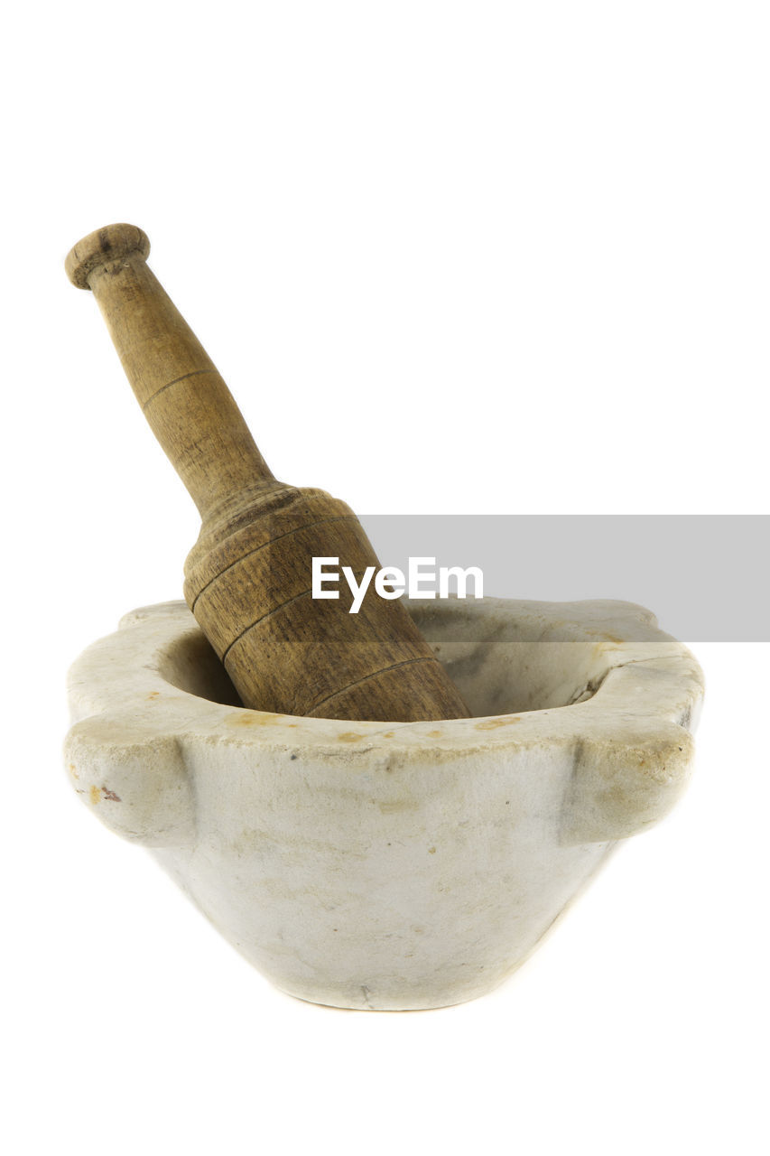 Close-up of mortar and pestle against white background