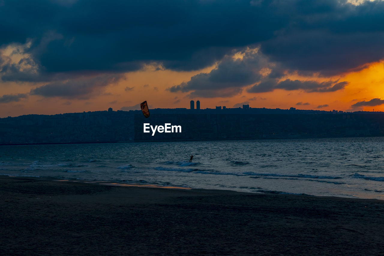 Kite surfing at dusk in qiryat yam israel