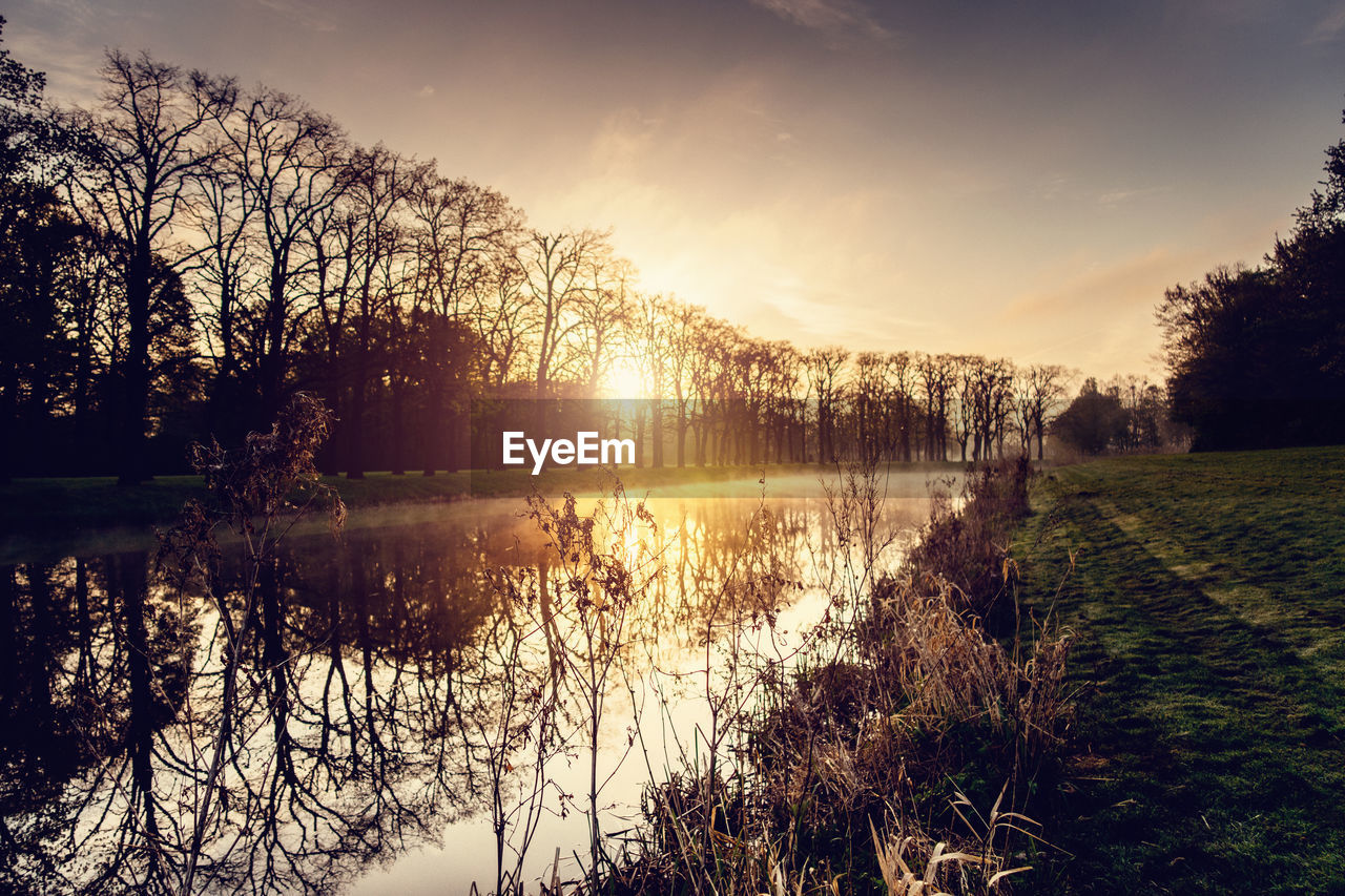 Scenic view of lake at sunset