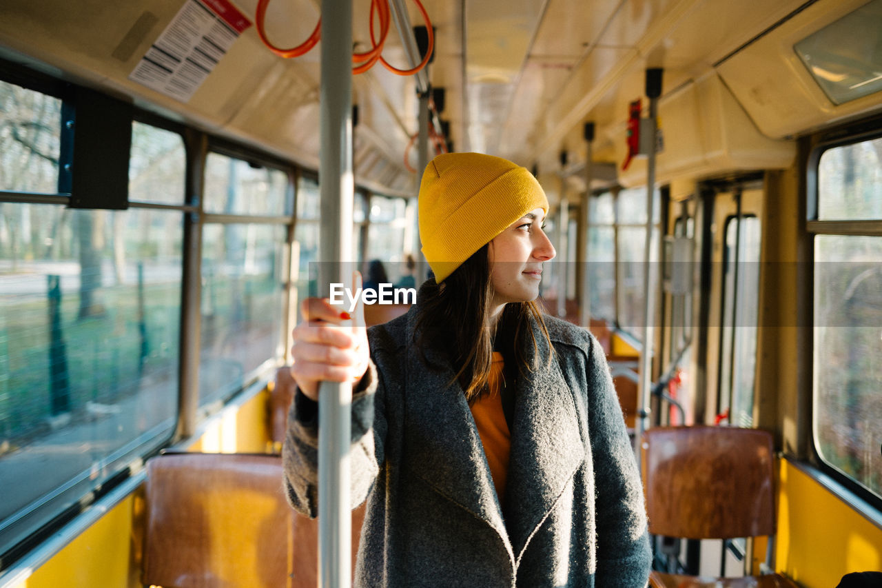 Young woman looking through tram window