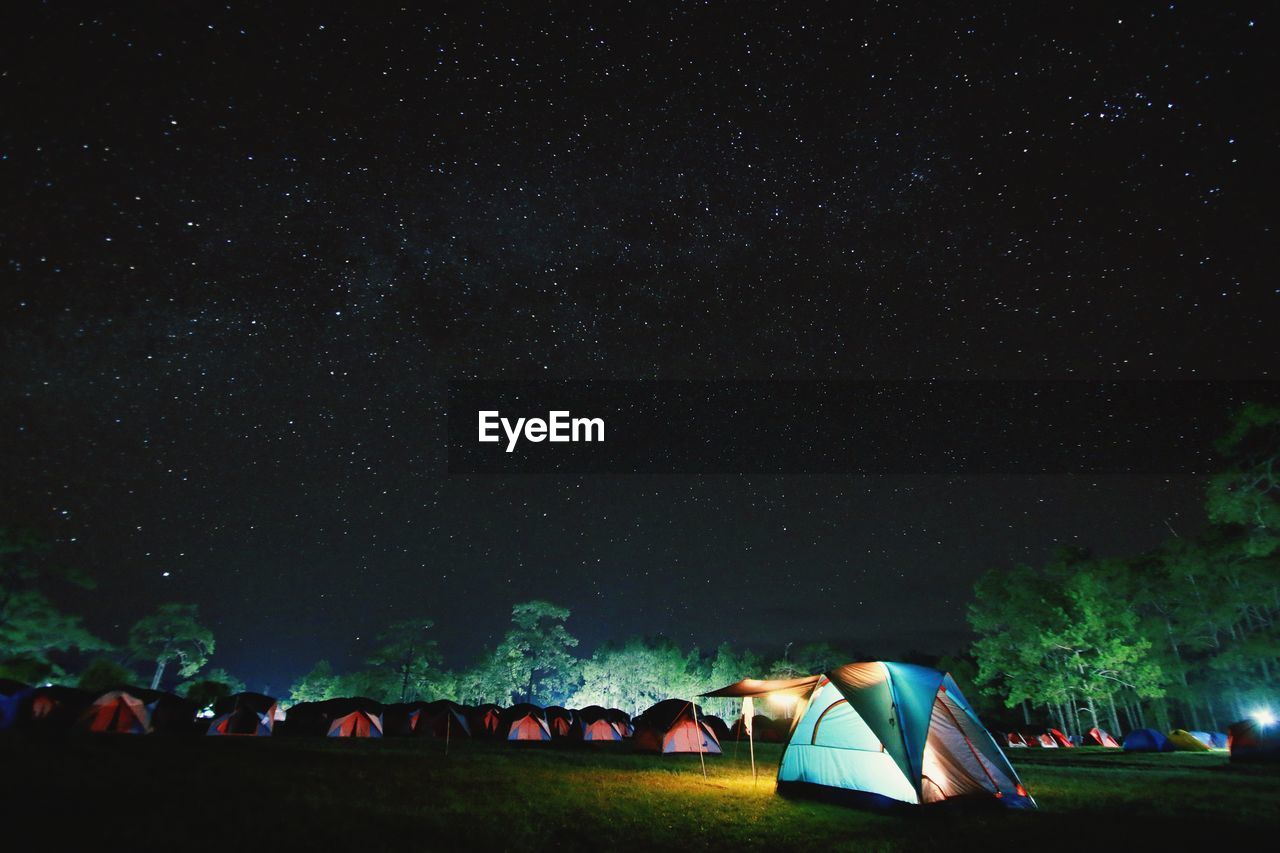 Tent on field against sky at night