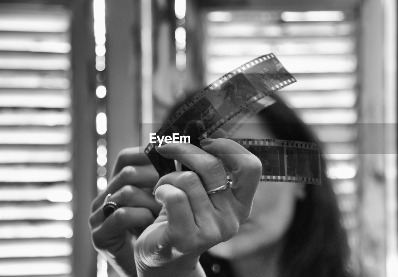 Close-up of woman looking film reel at home