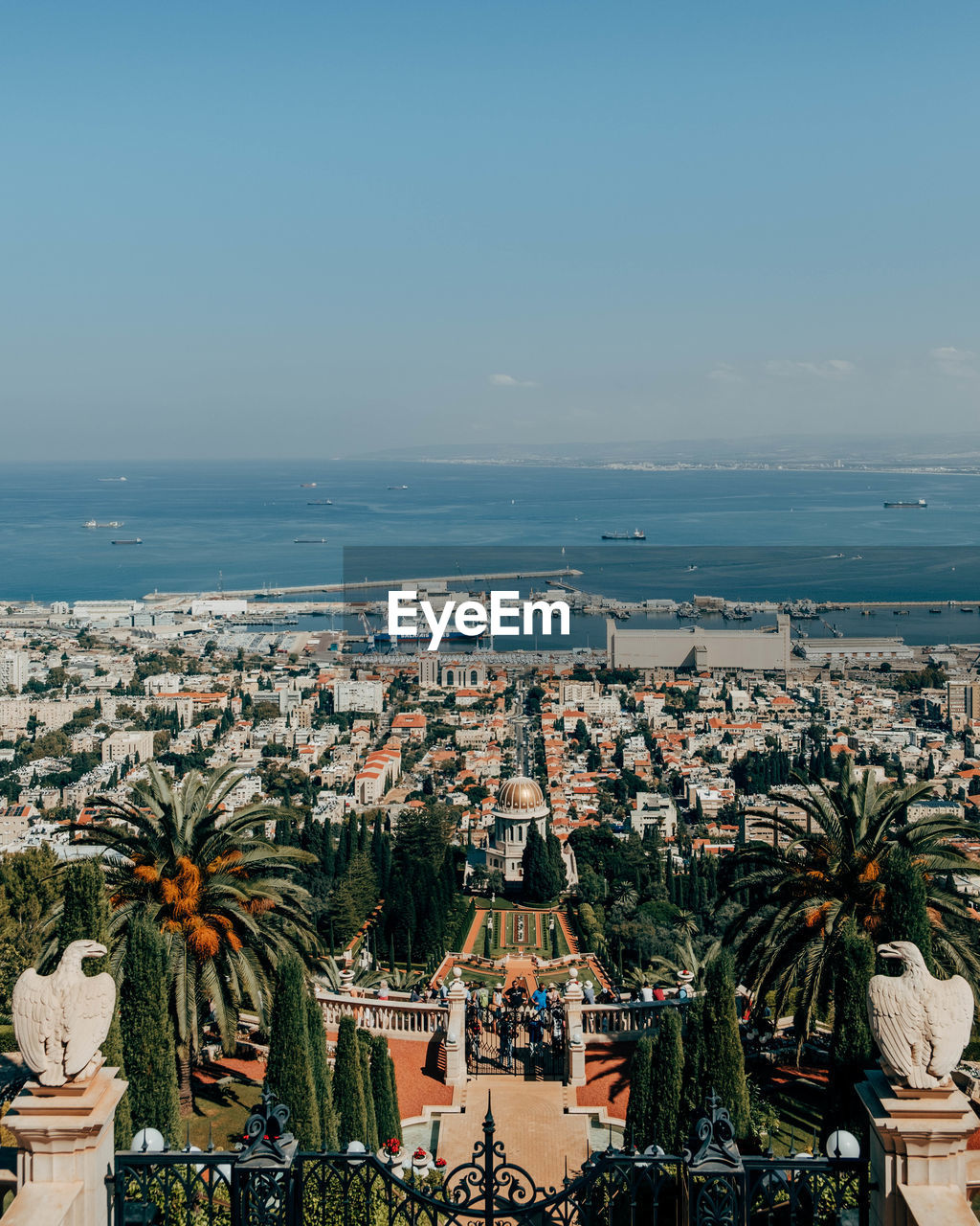 High angle view of city by sea against clear sky