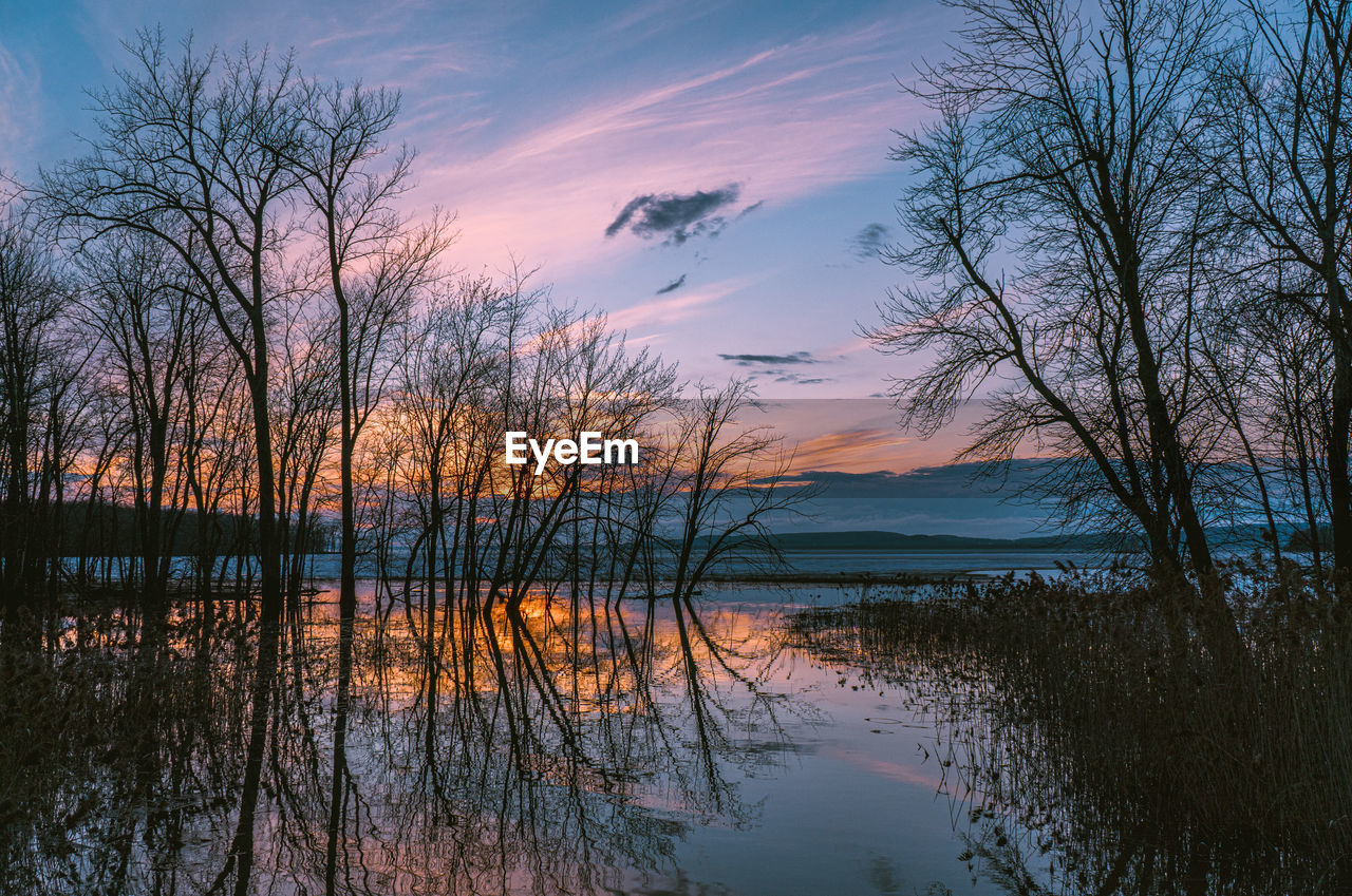 Scenic view of lake against sky during sunset