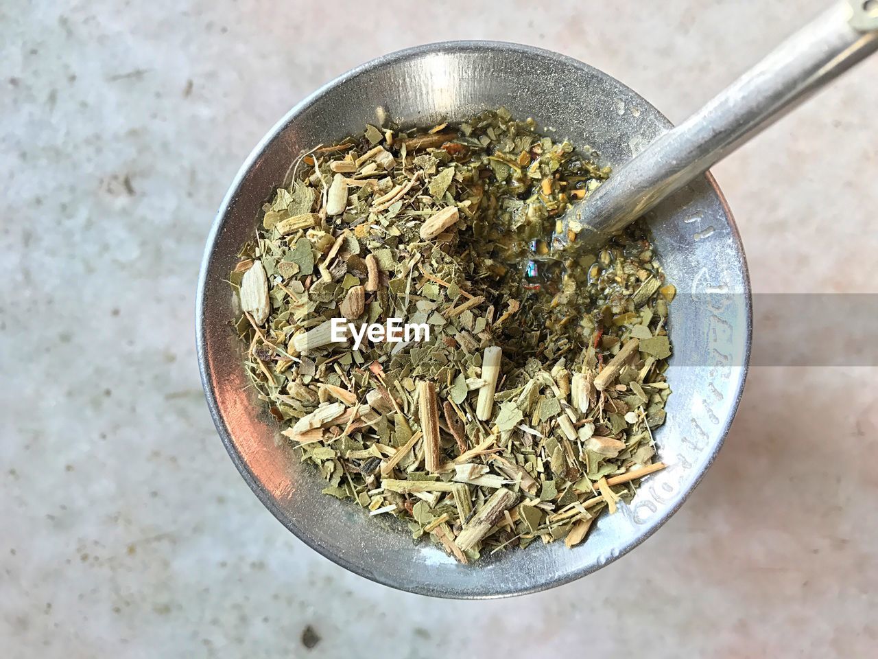 High angle view of herbs in mortar and pestle on table