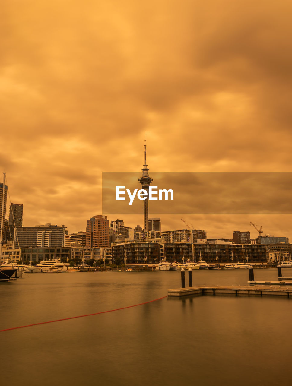 VIEW OF BUILDINGS IN CITY AGAINST CLOUDY SKY