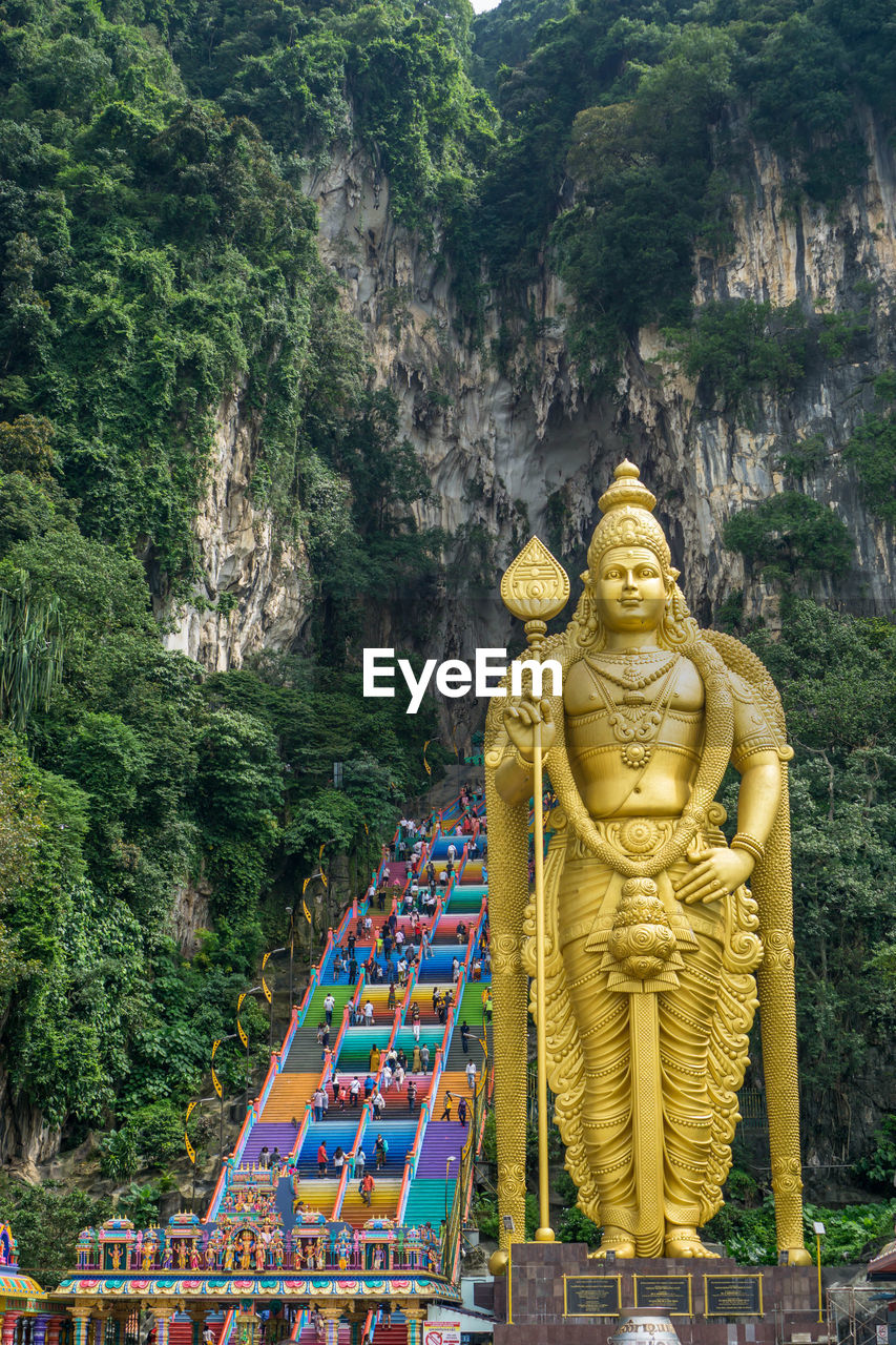 Batu caves in kuala lumpur colorful stairs with golden statue